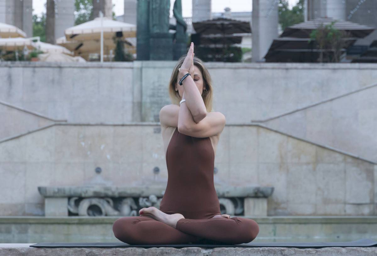 Woman practicing diaphragmatic breathing with hands on ribcage demonstrating Airflow Control